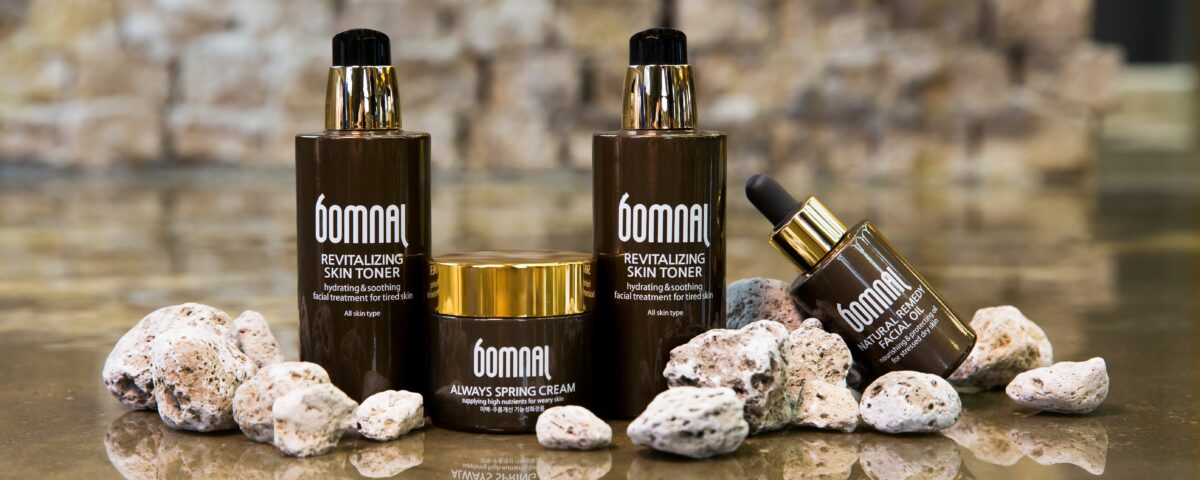 Valorisation d'une marque de cosmétiques : gamme de soins aux bouchons dorés sur une surface réfléchissante